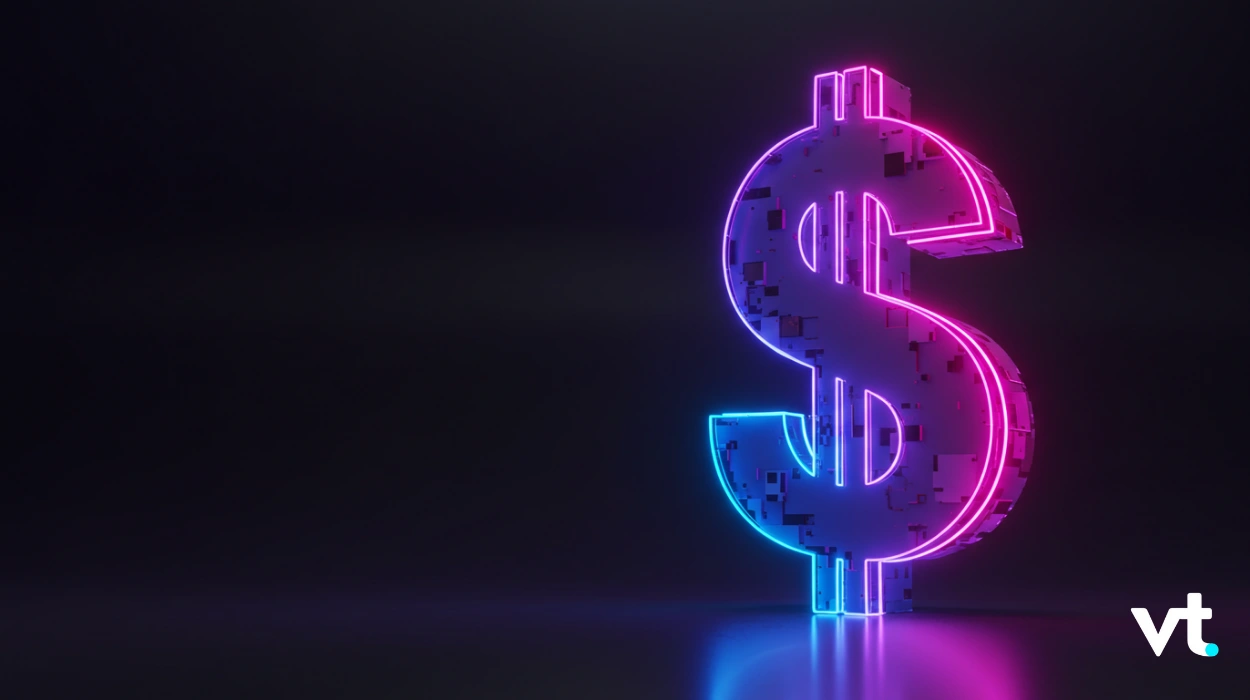 Large neon dollar sign sculpture glowing pink and blue on a dark background, with a VT logo in the bottom-right corner.